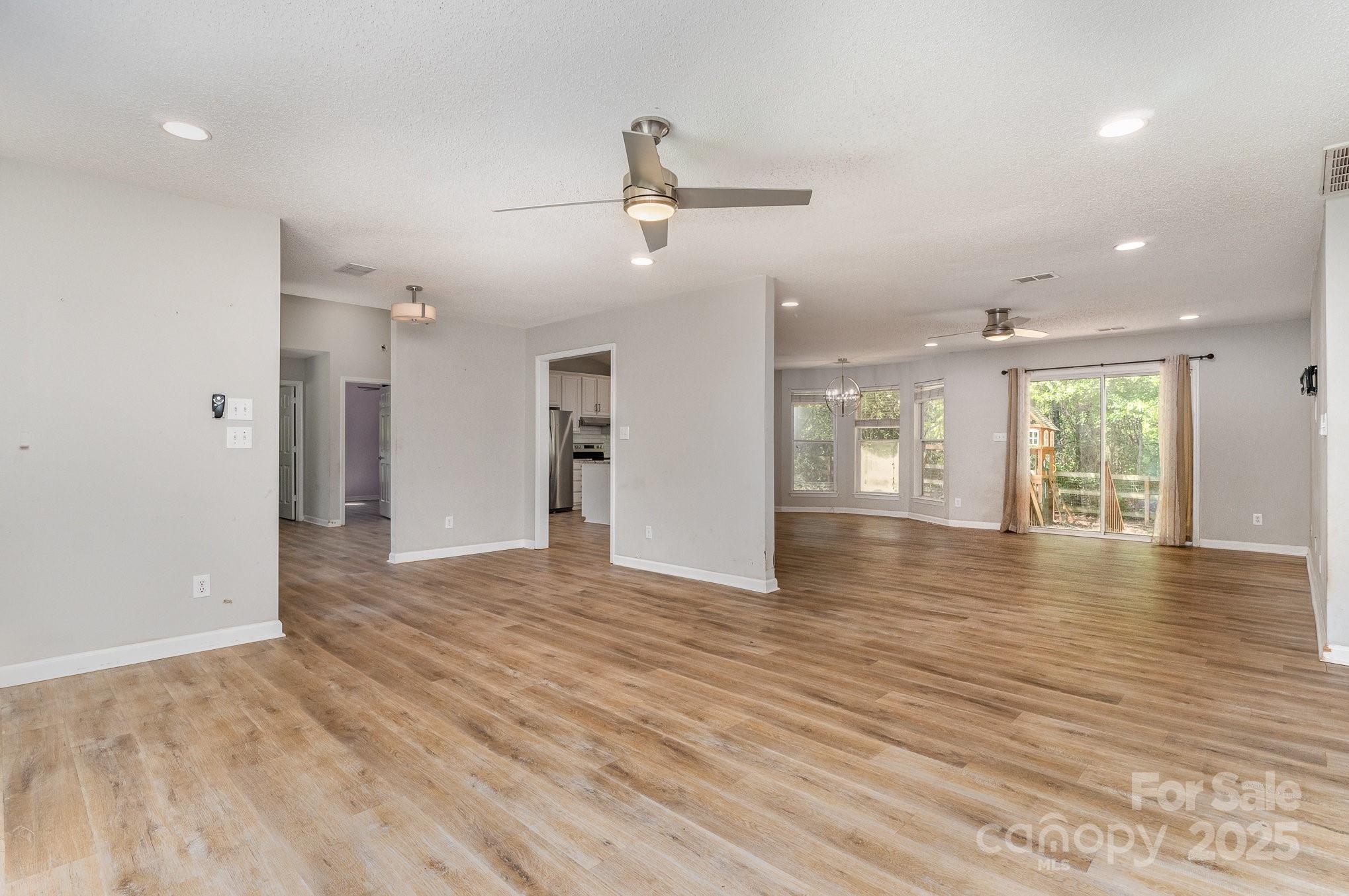 2014 Cardinal Loop Stanley, NC 28164 - Photo 8 of 40 an empty room with wooden floor and natural light