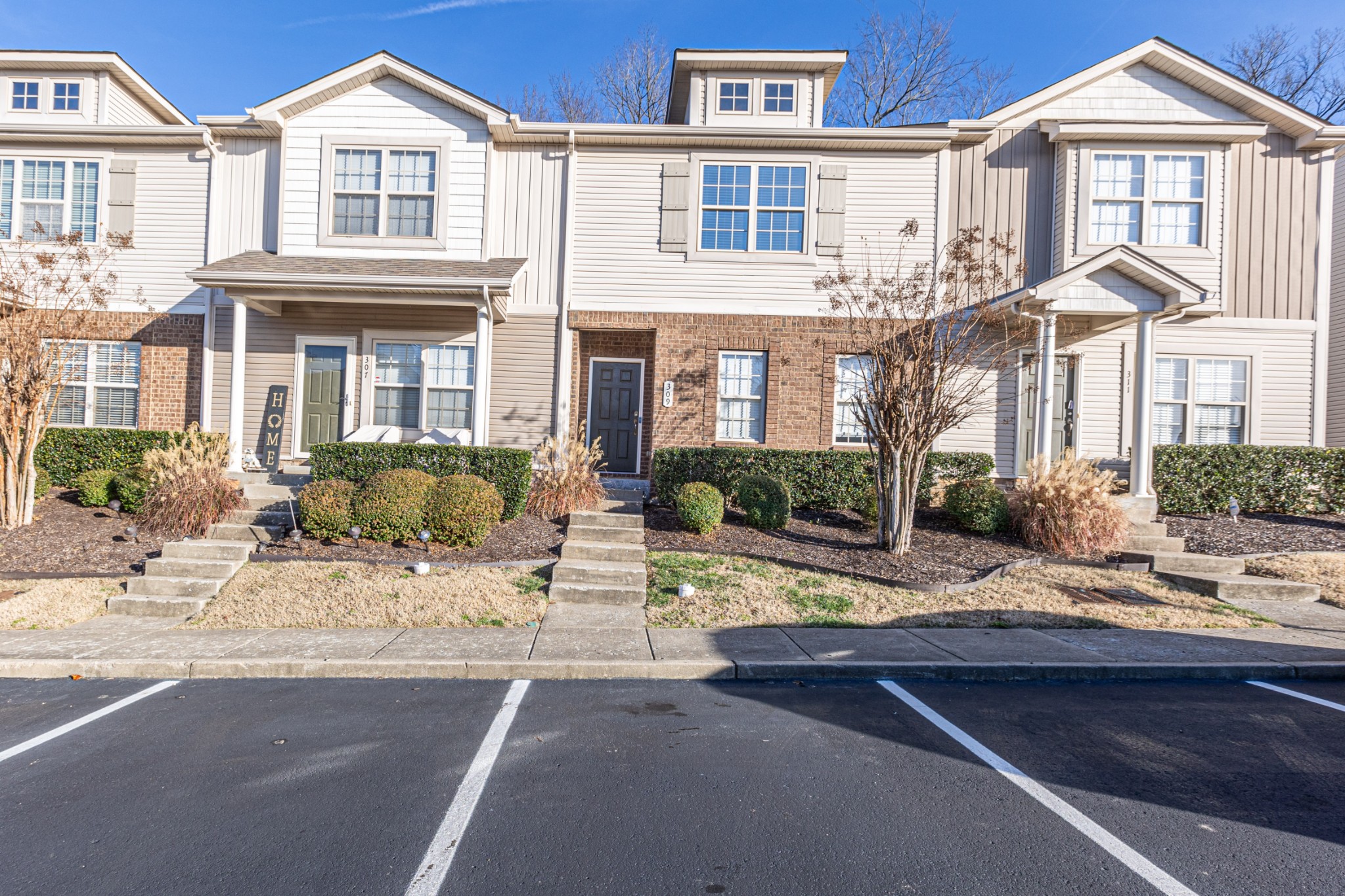 735 Tulip Grove Road, Unit 309 Hermitage, TN 37076 - Photo 1 of 18 a view of a white house with large windows next to a road