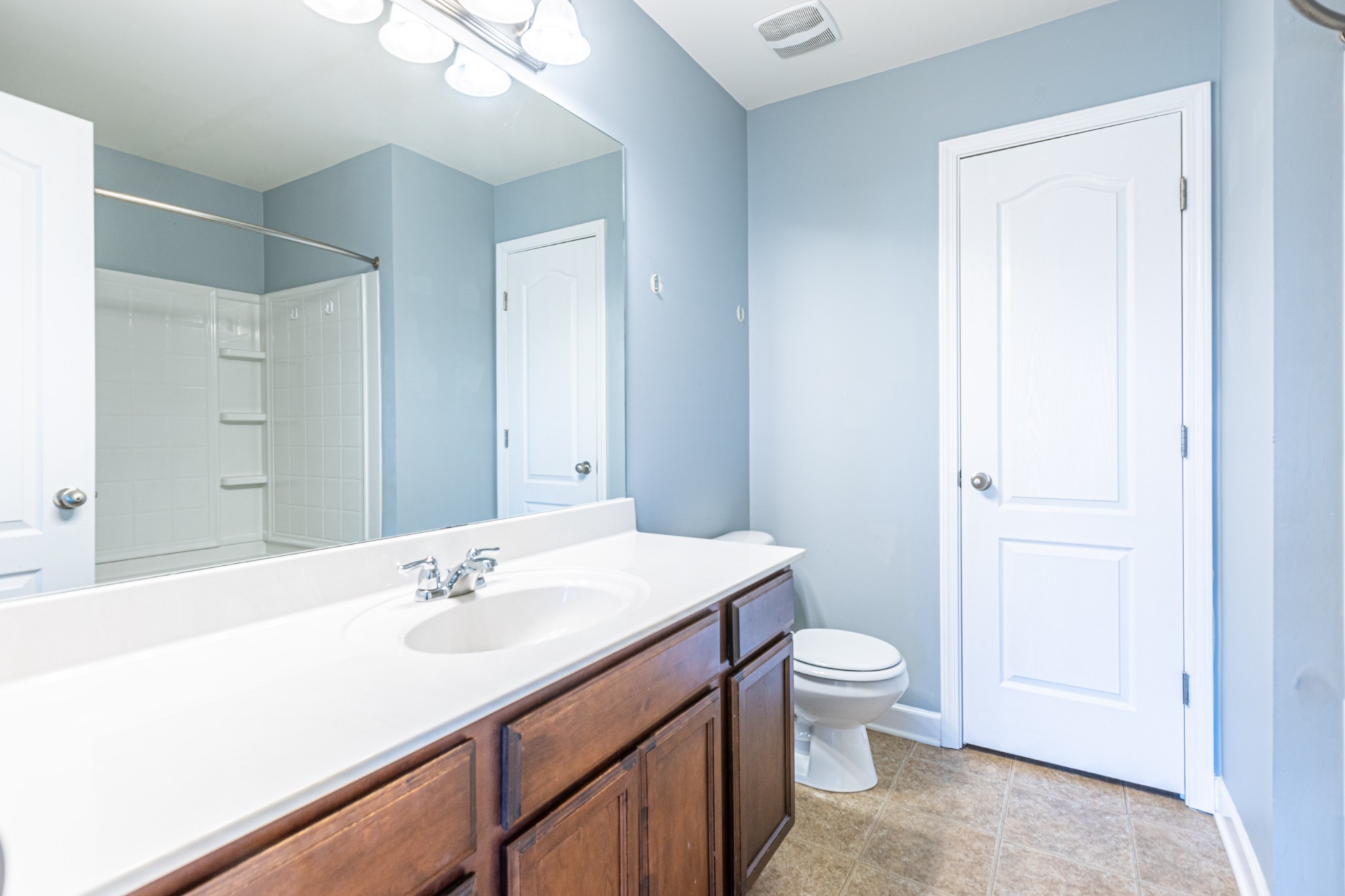 735 Tulip Grove Road, Unit 309 Hermitage, TN 37076 - Photo 12 of 18 a bathroom with a sink a toilet a shower and a mirror