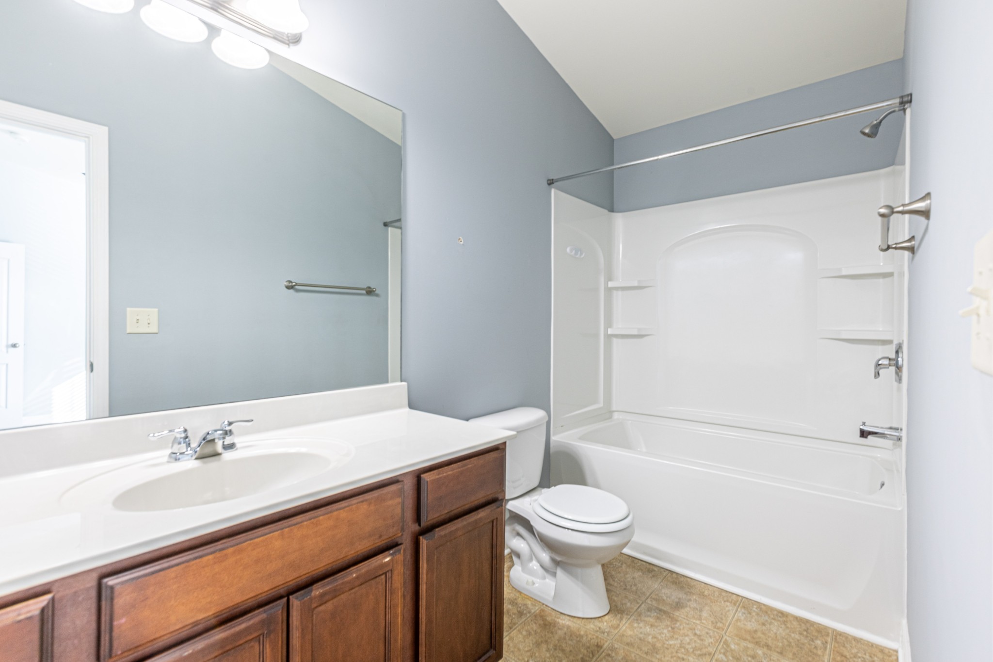 735 Tulip Grove Road, Unit 309 Hermitage, TN 37076 - Photo 13 of 18 a bathroom with a sink a toilet and shower