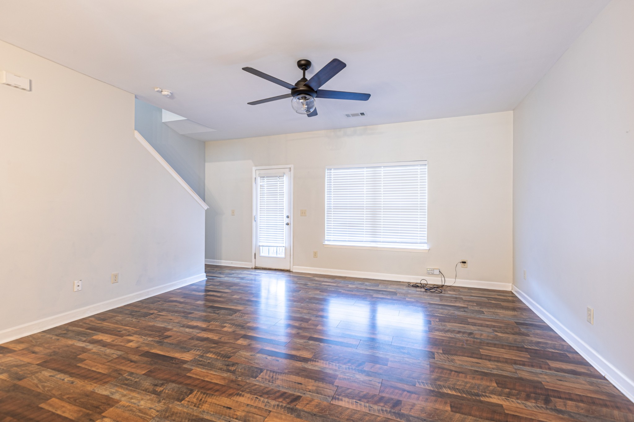 735 Tulip Grove Road, Unit 309 Hermitage, TN 37076 - Photo 3 of 18 an empty room with wooden floor a ceiling fan and windows