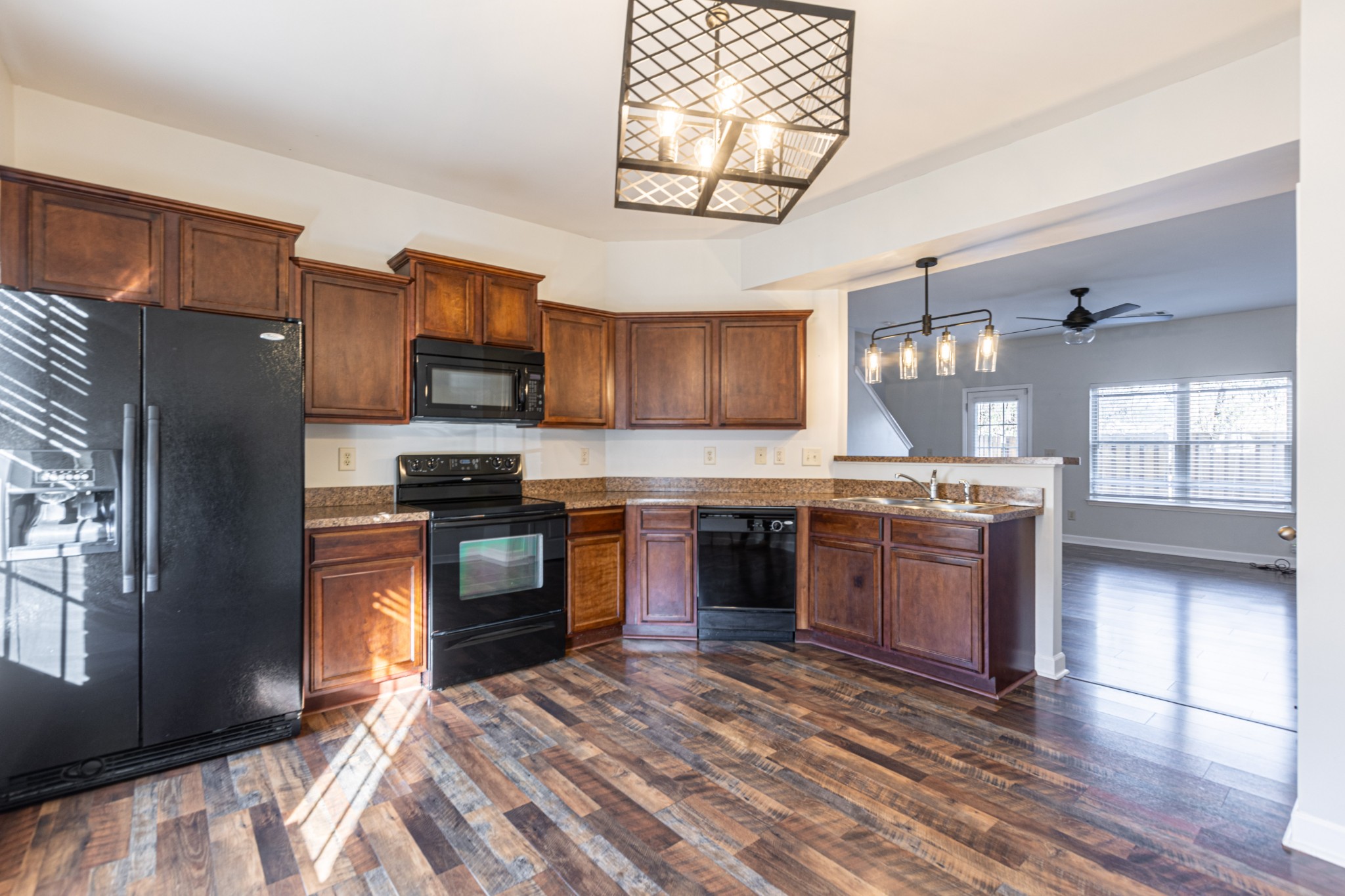 735 Tulip Grove Road, Unit 309 Hermitage, TN 37076 - Photo 4 of 18 a large kitchen with stainless steel appliances granite countertop a stove refrigerator and a microwave oven