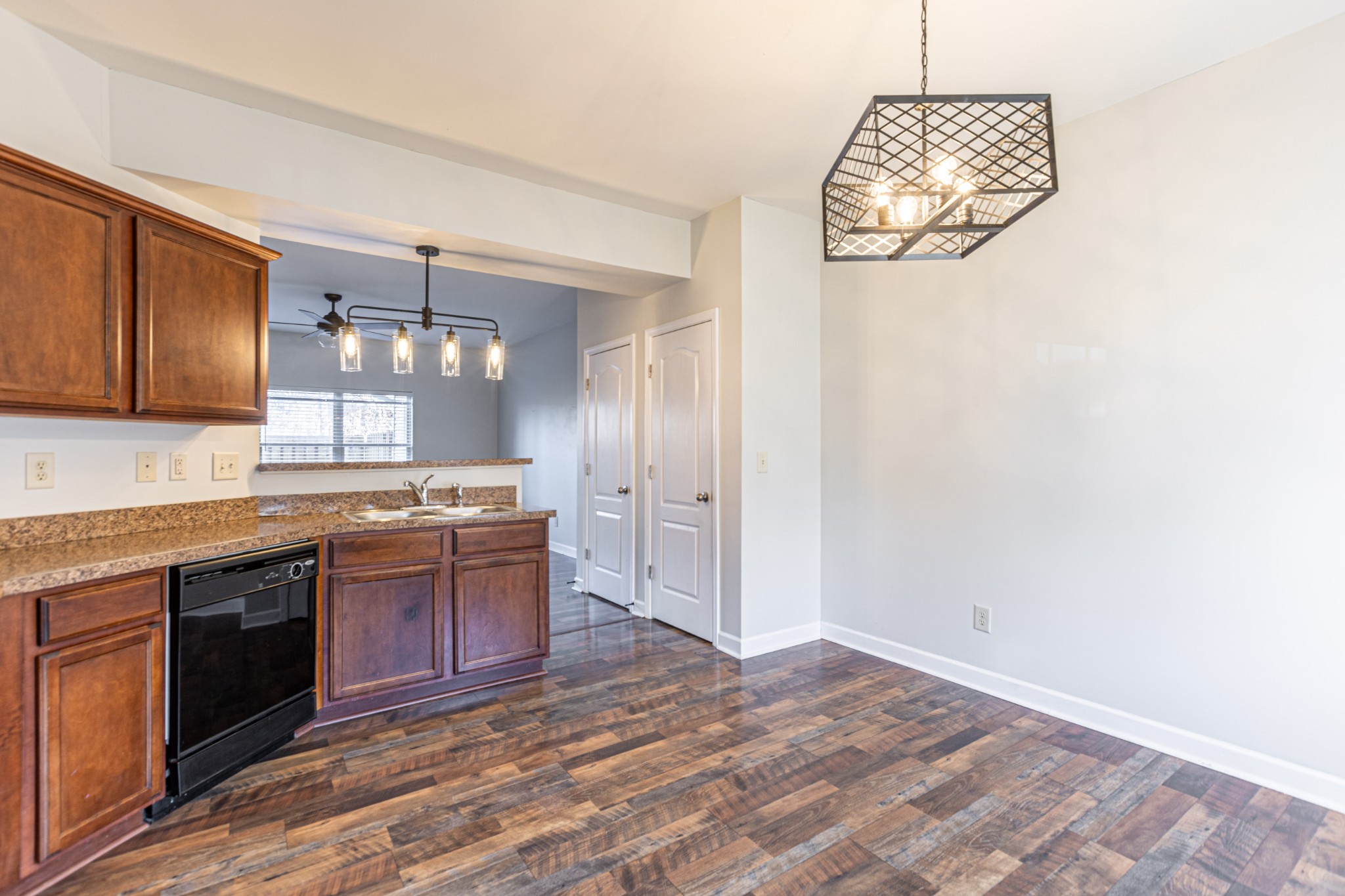 735 Tulip Grove Road, Unit 309 Hermitage, TN 37076 - Photo 8 of 18 a large kitchen with kitchen island granite countertop wooden cabinets and stainless steel appliances