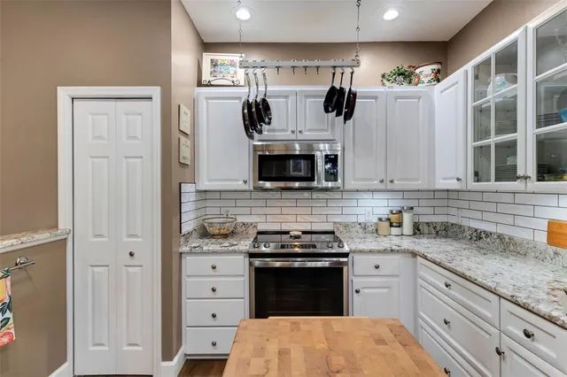 a kitchen with stainless steel appliances granite countertop a stove and a sink