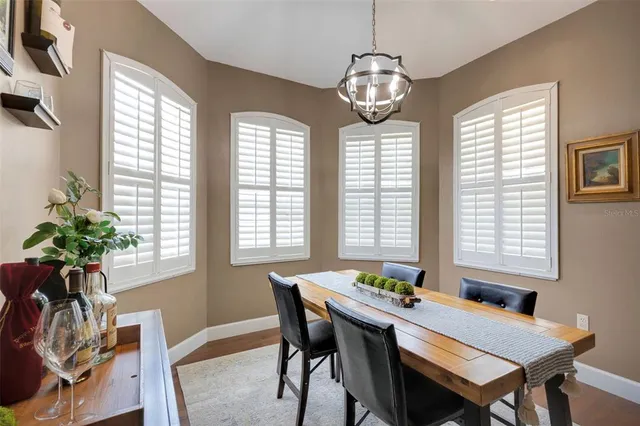 a dining room with furniture and a wooden floor