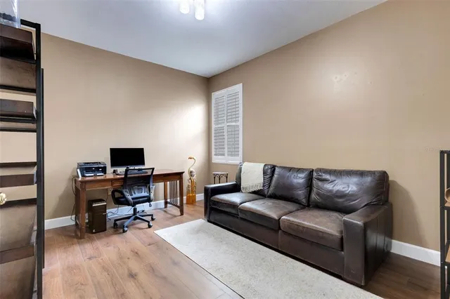 a view of a workspace with furniture and a window