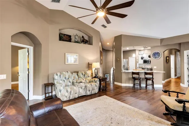 a kitchen with granite countertop a sink a counter top space stainless steel appliances and wooden floor