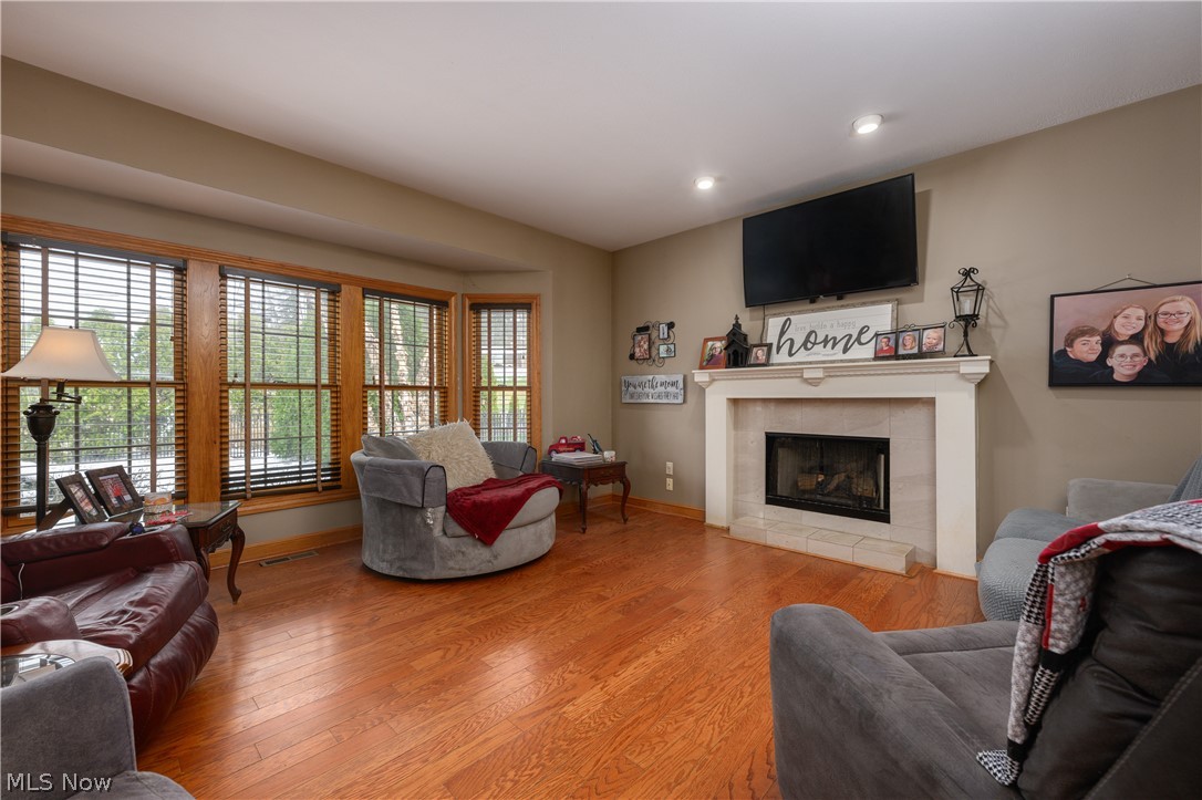 806 Forrest Ridge Drive Dover, OH 44622 - Photo 11 of 36 Living area featuring wood-type flooring, a tile fireplace, and recessed lighting