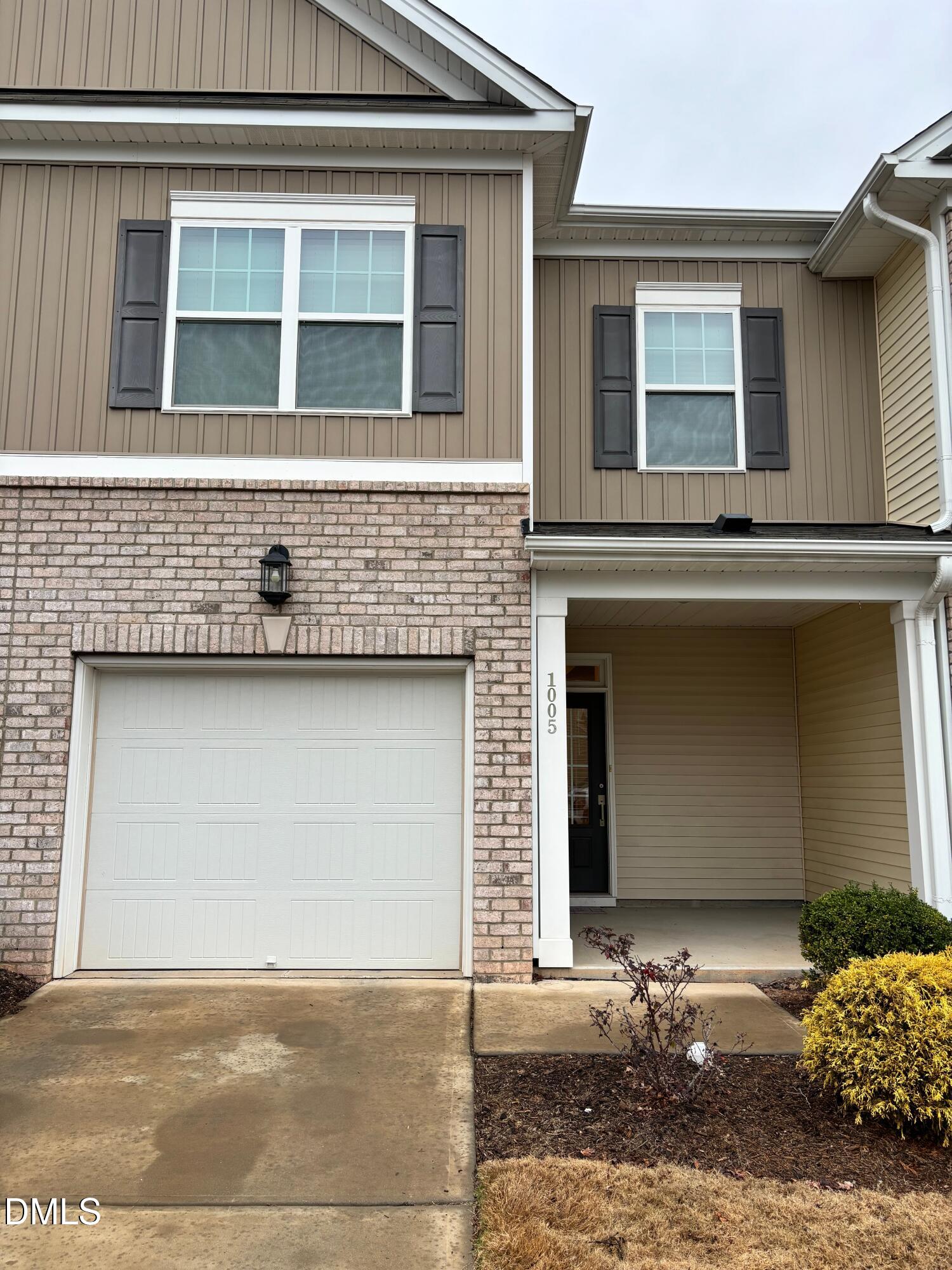 a front view of a house with a garage