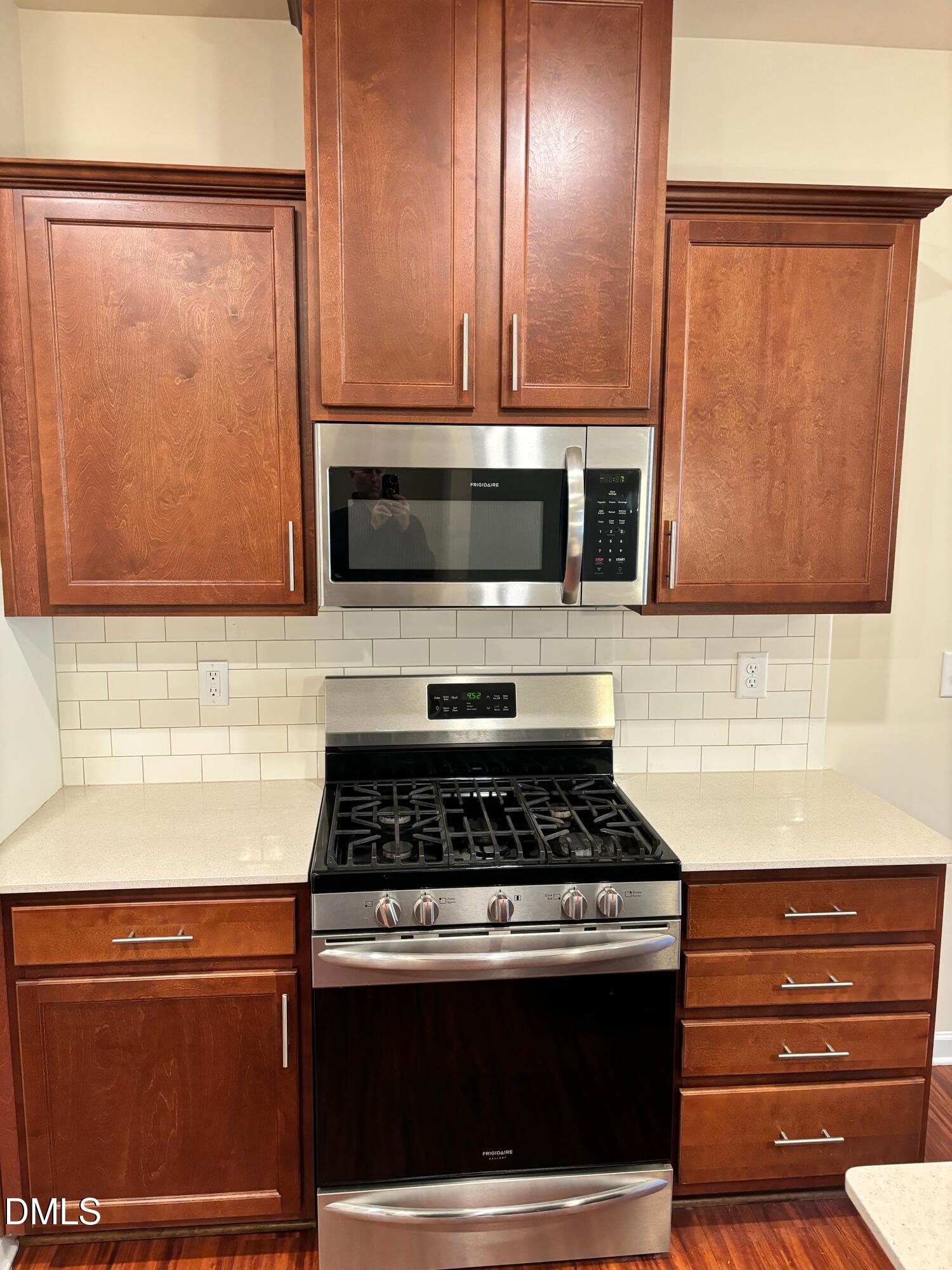 1005 Epiphany Road Morrisville, NC 27560 - Photo 9 of 21 a kitchen with wooden cabinets and a stove top oven