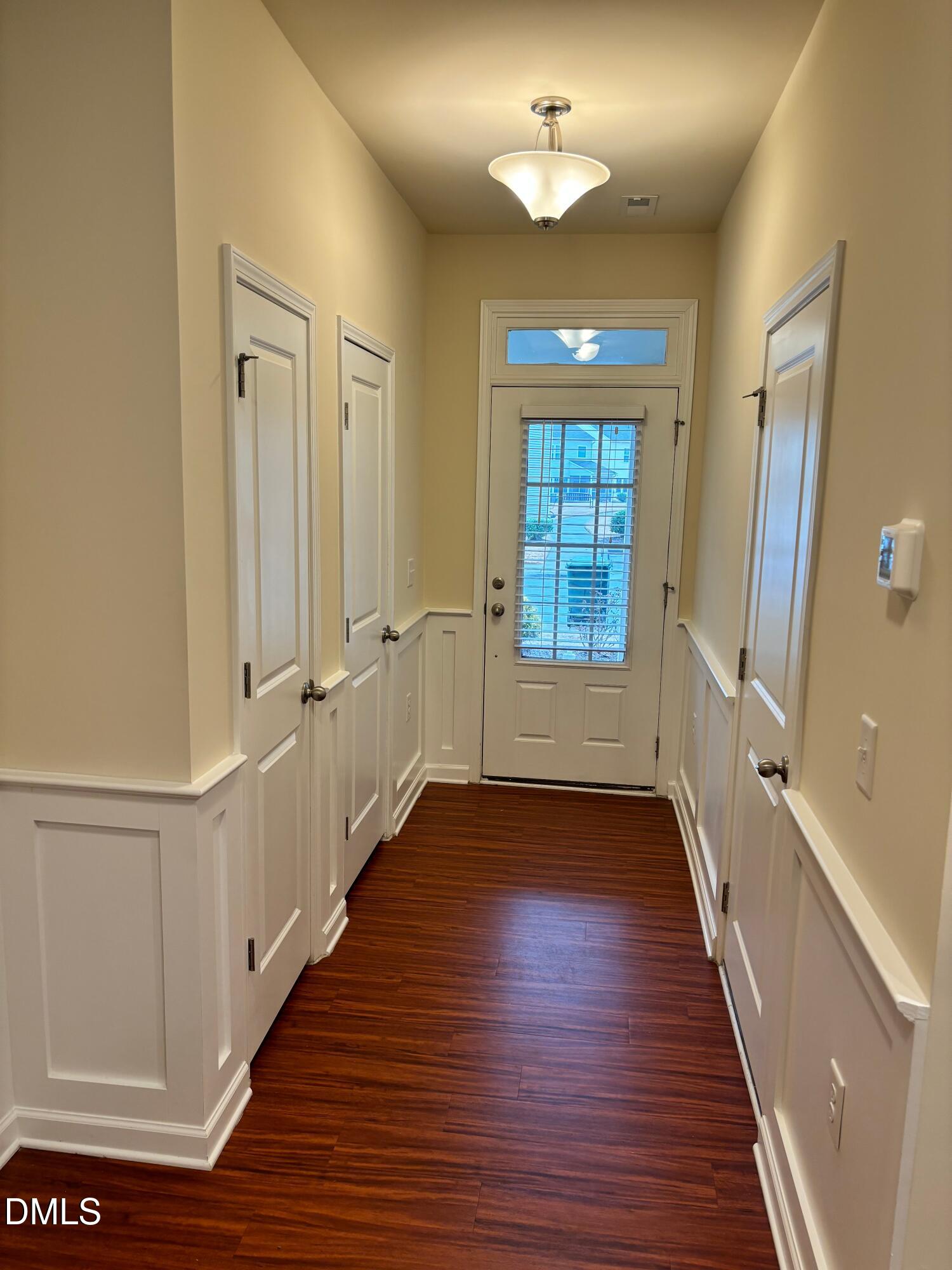 1005 Epiphany Road Morrisville, NC 27560 - Photo 5 of 21 a view of a hallway with wooden floor and staircase