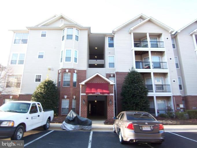 1600 Spring Gate Dr., Unit 2113 McLean, VA 22102 - Photo 6 of 6 a front view of a house with parking space