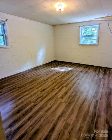 a kitchen with cabinets and wooden floor