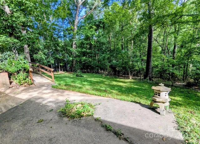 a view of a patio with table and chairs and potted plants