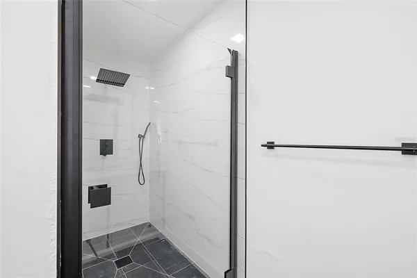 a bathroom with a shower and a sink