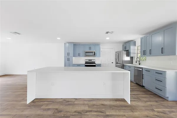 a large white kitchen with cabinets