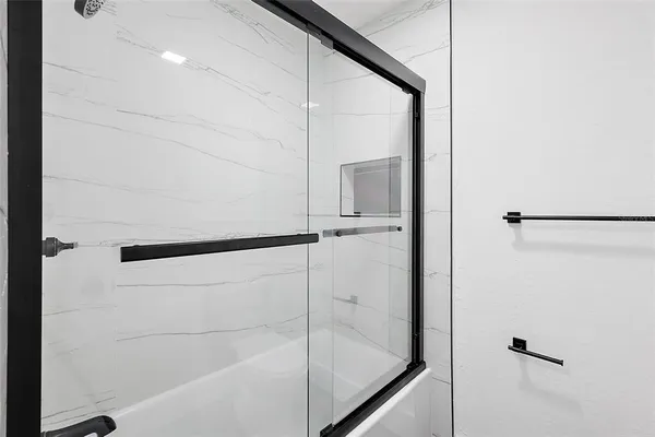 a bathroom with a glass shower door