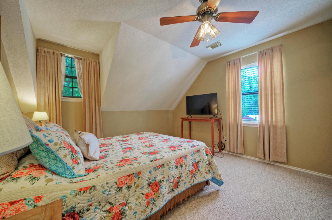 828 Water Street Manor, TX 78653 - Photo 11 of 19 a bedroom with a bed and a chandelier