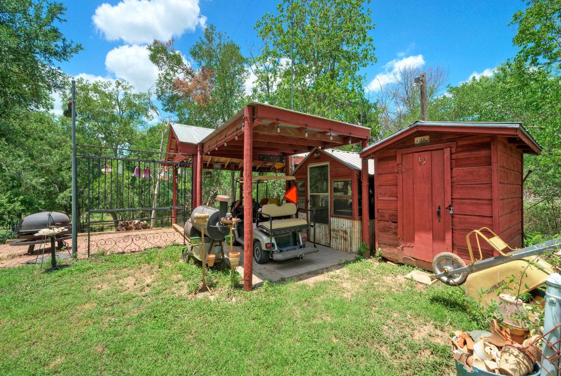 828 Water Street Manor, TX 78653 - Photo 14 of 19 a view of a chair and table in backyard of the house