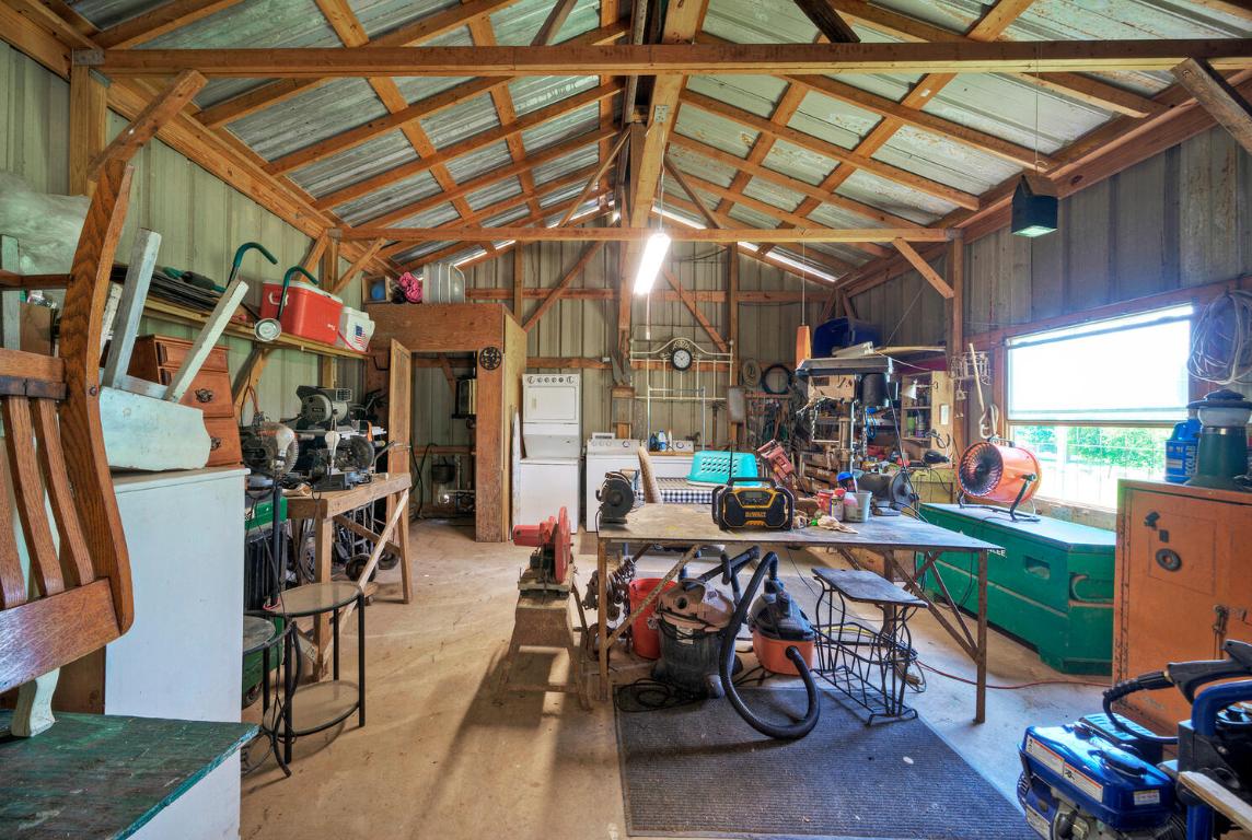 828 Water Street Manor, TX 78653 - Photo 17 of 19 a room with lots of wooden furniture and a table