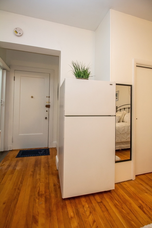 1253 Beacon Street, Unit C4 Brookline, MA 02446 - Photo 6 of 10 a view of a room with wooden floor and a refrigerator