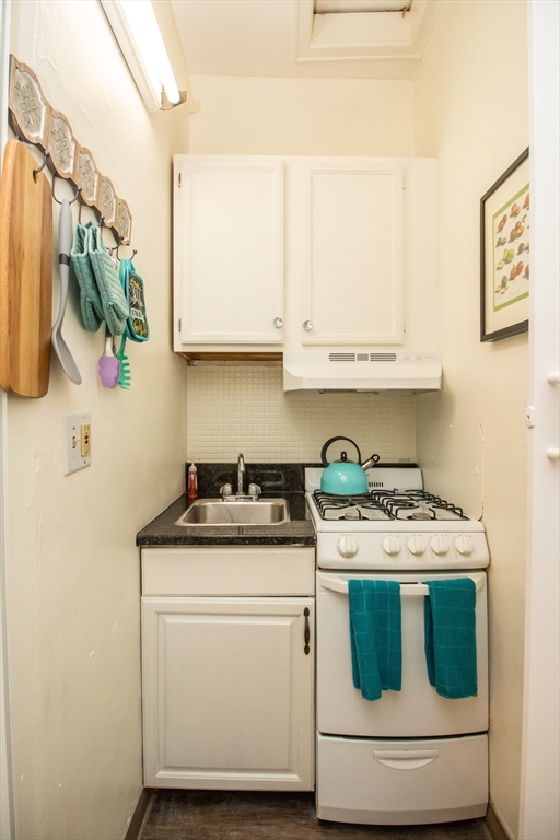 1253 Beacon Street, Unit C4 Brookline, MA 02446 - Photo 10 of 10 a kitchen with stainless steel appliances granite countertop a stove and a white cabinets