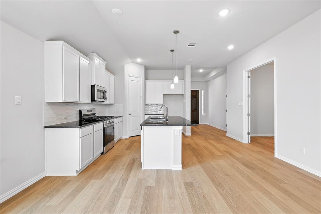 530 Red Barn Drive Van Alstyne, TX 75495 - Photo 4 of 40 Kitchen with stainless steel appliances, dark countertops, backsplash, light wood-style flooring, and recessed lighting