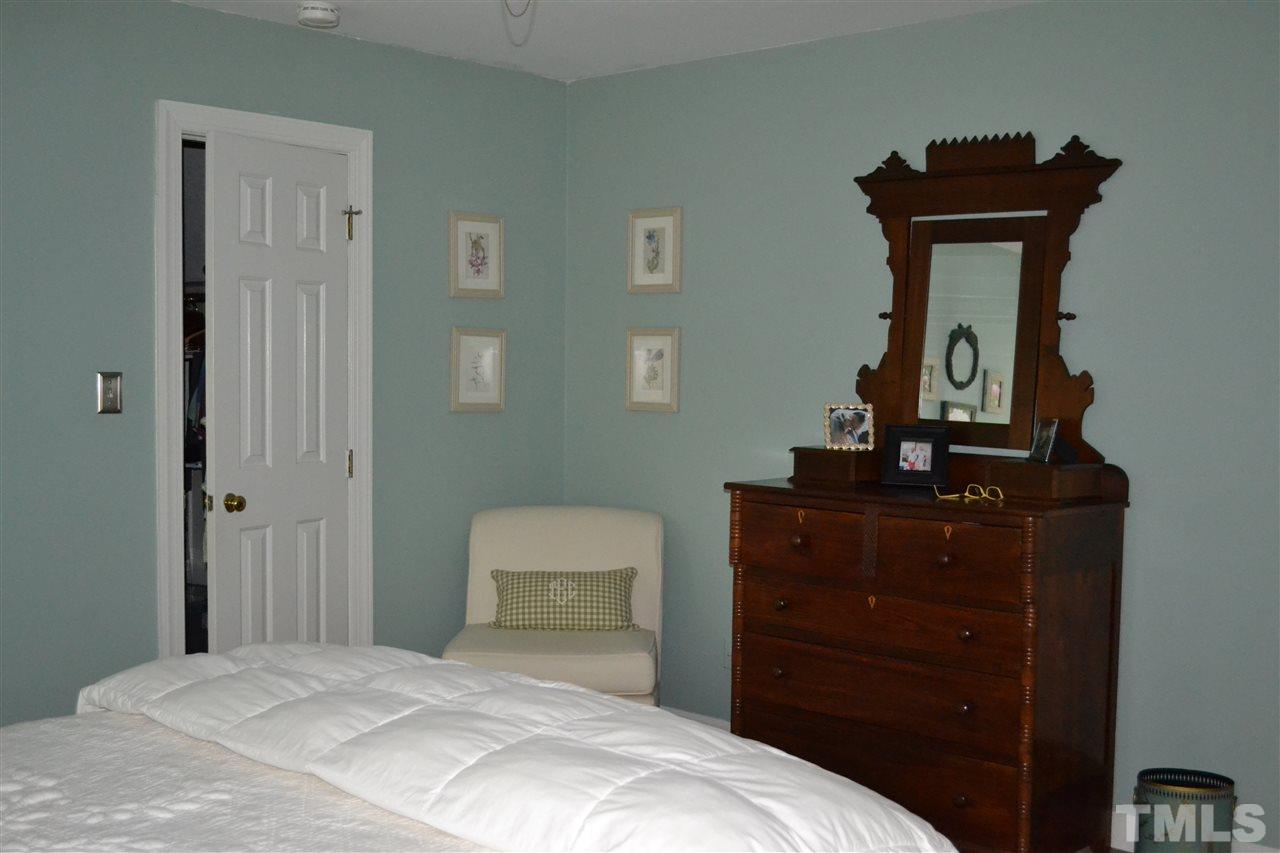 2320 Pastille Lane Raleigh, NC 27612 - Photo 15 of 25 a bedroom with a bed and a mirror on dresser