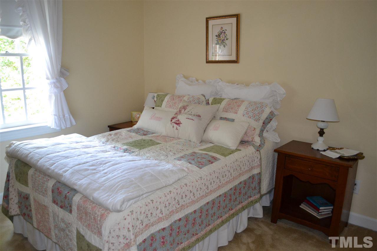 2320 Pastille Lane Raleigh, NC 27612 - Photo 18 of 25 a bedroom with a bed and a fireplace