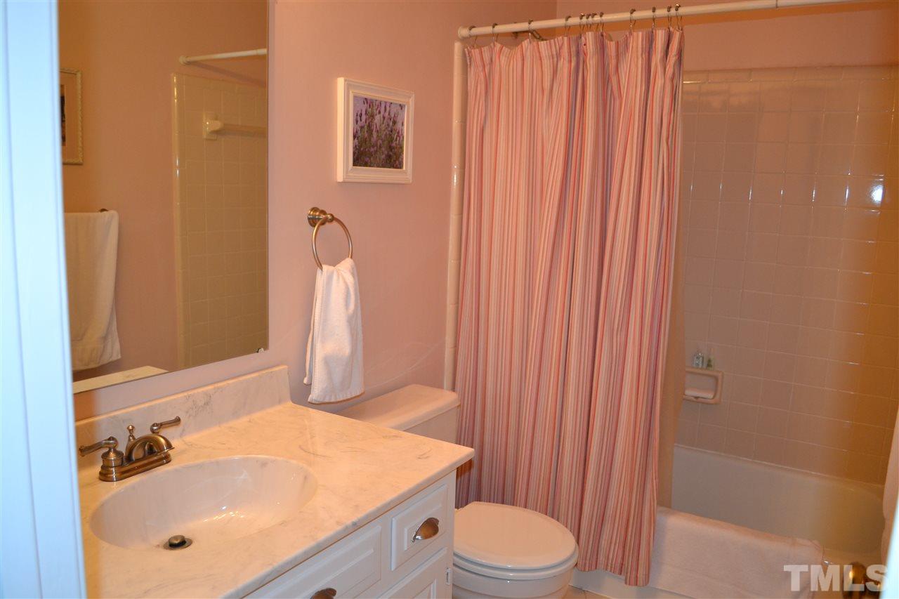 2320 Pastille Lane Raleigh, NC 27612 - Photo 19 of 25 a bathroom with a sink a toilet and shower curtain