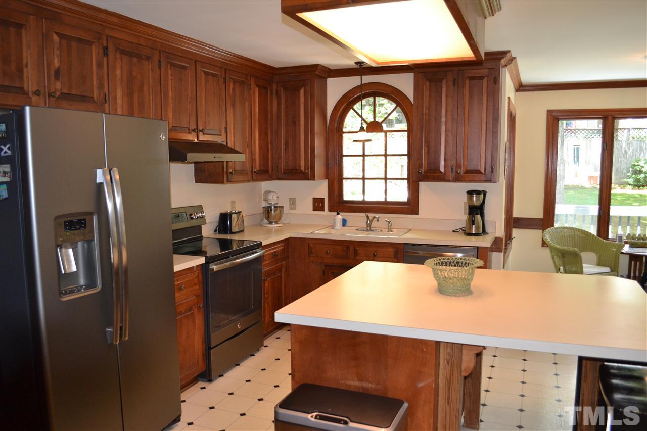 2320 Pastille Lane Raleigh, NC 27612 - Photo 9 of 25 a kitchen with stainless steel appliances a refrigerator a sink a stove and cabinets