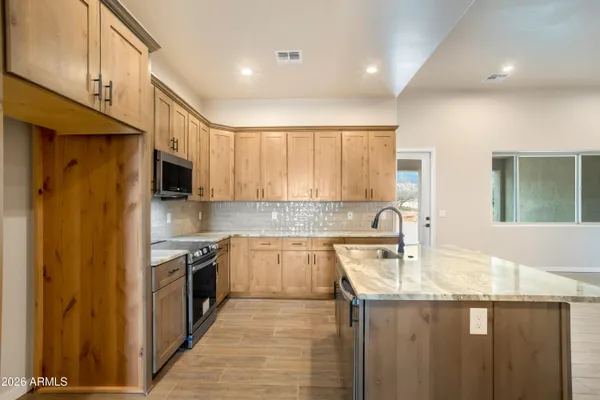 a view of a kitchen with a sink and a window