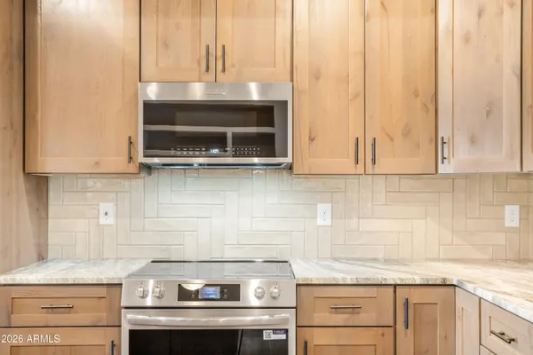 a kitchen with stainless steel appliances granite countertop a stove sink and cabinets
