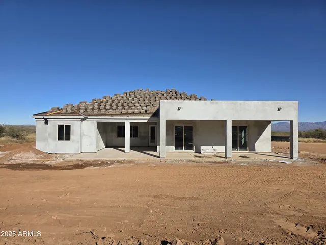 a view of a house with a swimming pool and sitting area