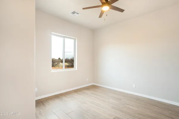 a bathroom with a granite countertop sink a toilet a mirror a bathtub and shower