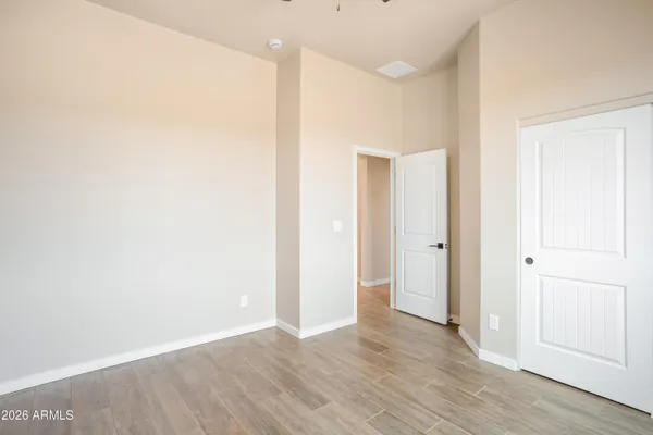 an empty room with a window and a fan