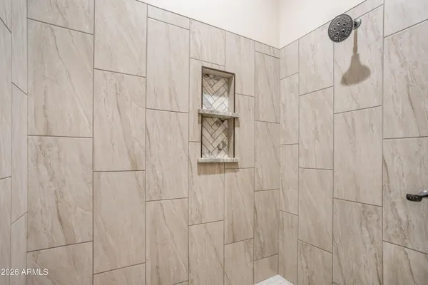 a spacious bathroom with a double vanity sink and a mirror