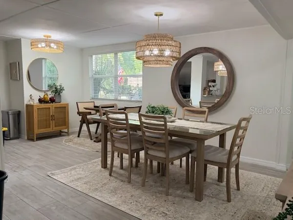 a view of a dining room with furniture and a chandelier