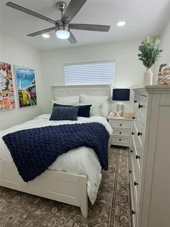 a bedroom with bed and a chandelier