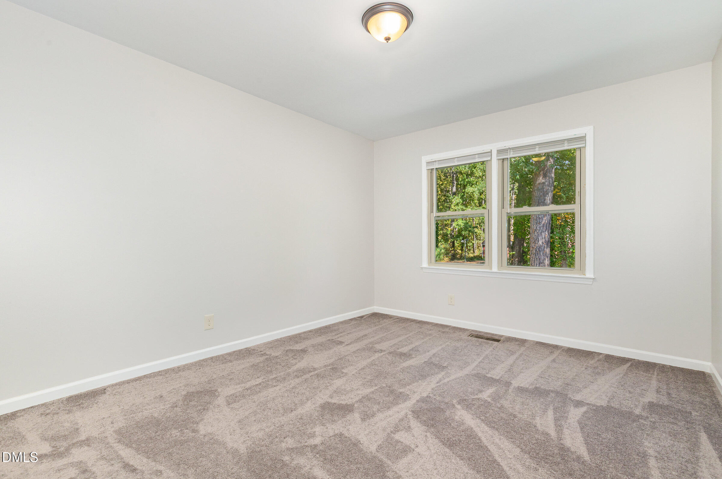 7020 Carpenter Fire Station Road Cary, NC 27519 - Photo 12 of 25 an empty room with a window