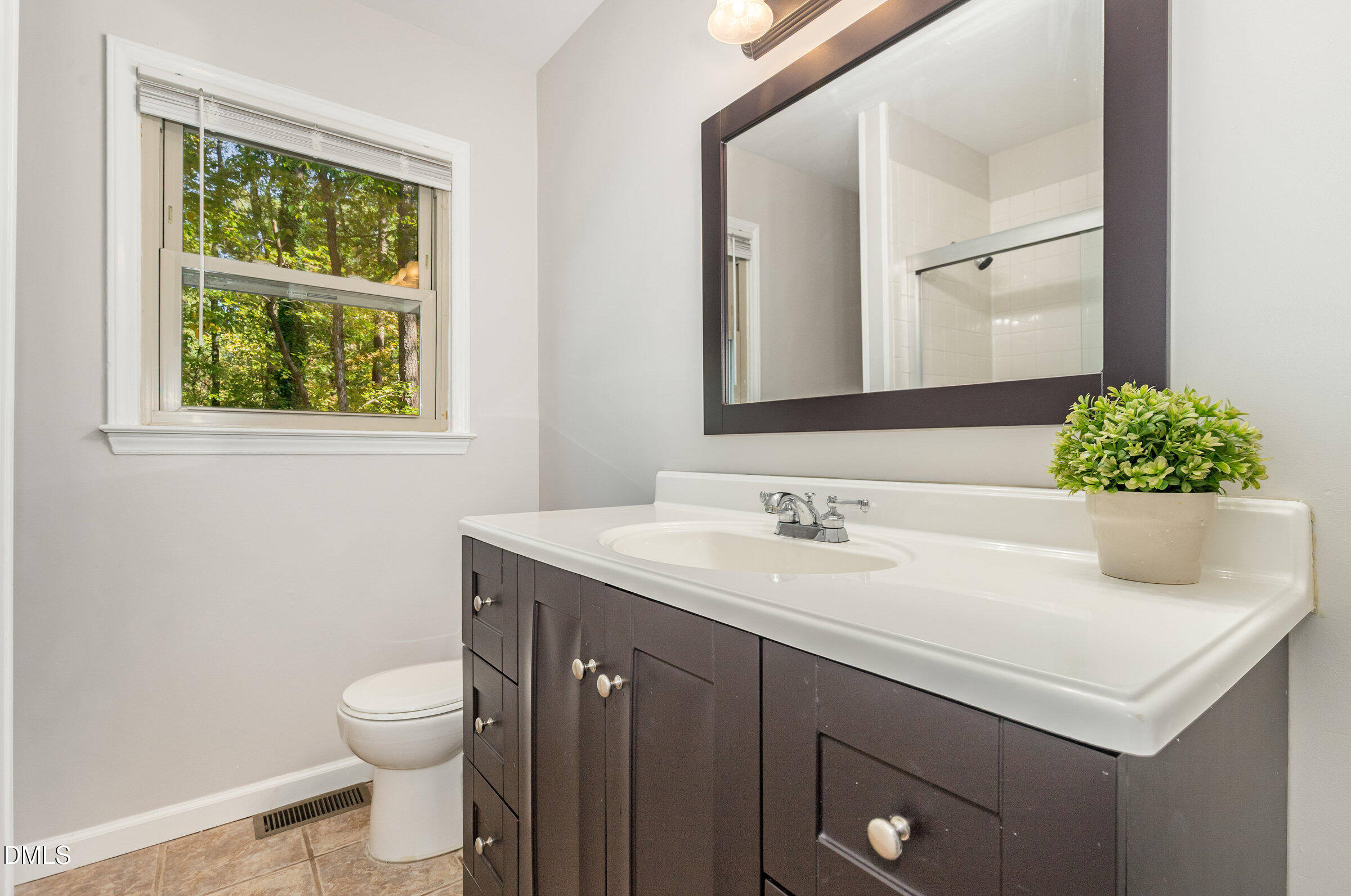 7020 Carpenter Fire Station Road Cary, NC 27519 - Photo 15 of 25 a bathroom with a toilet sink and mirror
