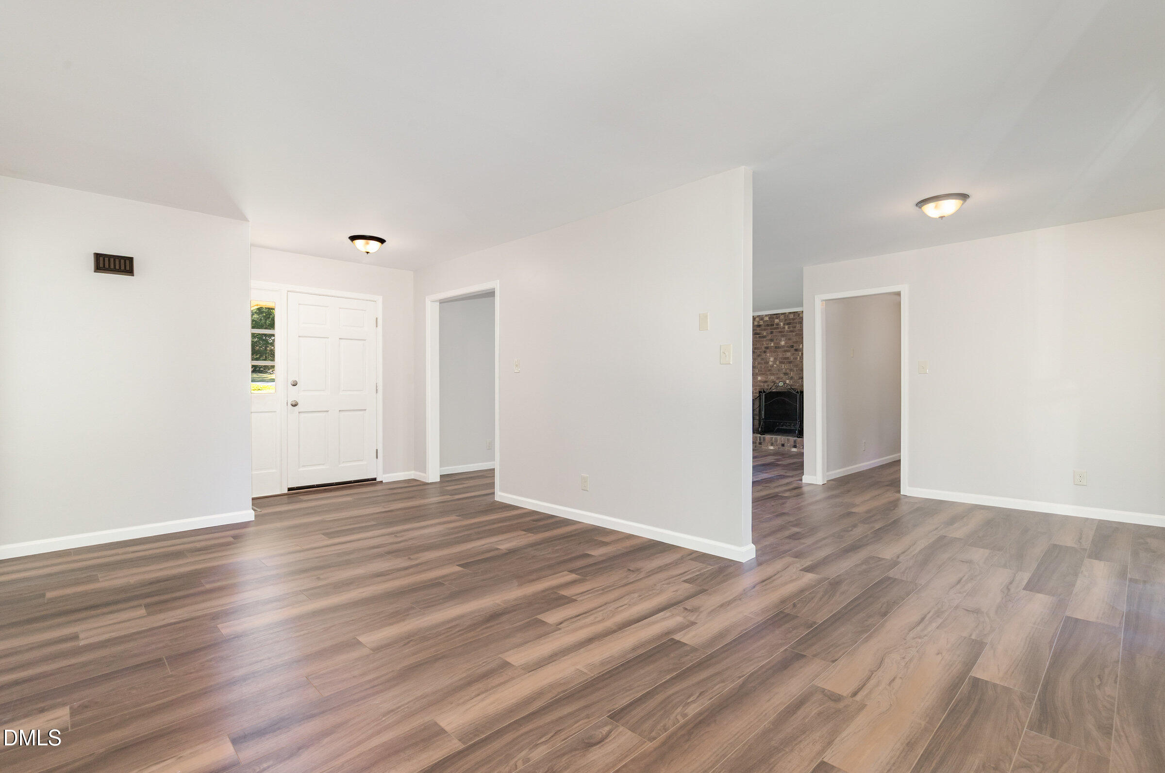 7020 Carpenter Fire Station Road Cary, NC 27519 - Photo 3 of 25 a view of an empty room with wooden floor and a window