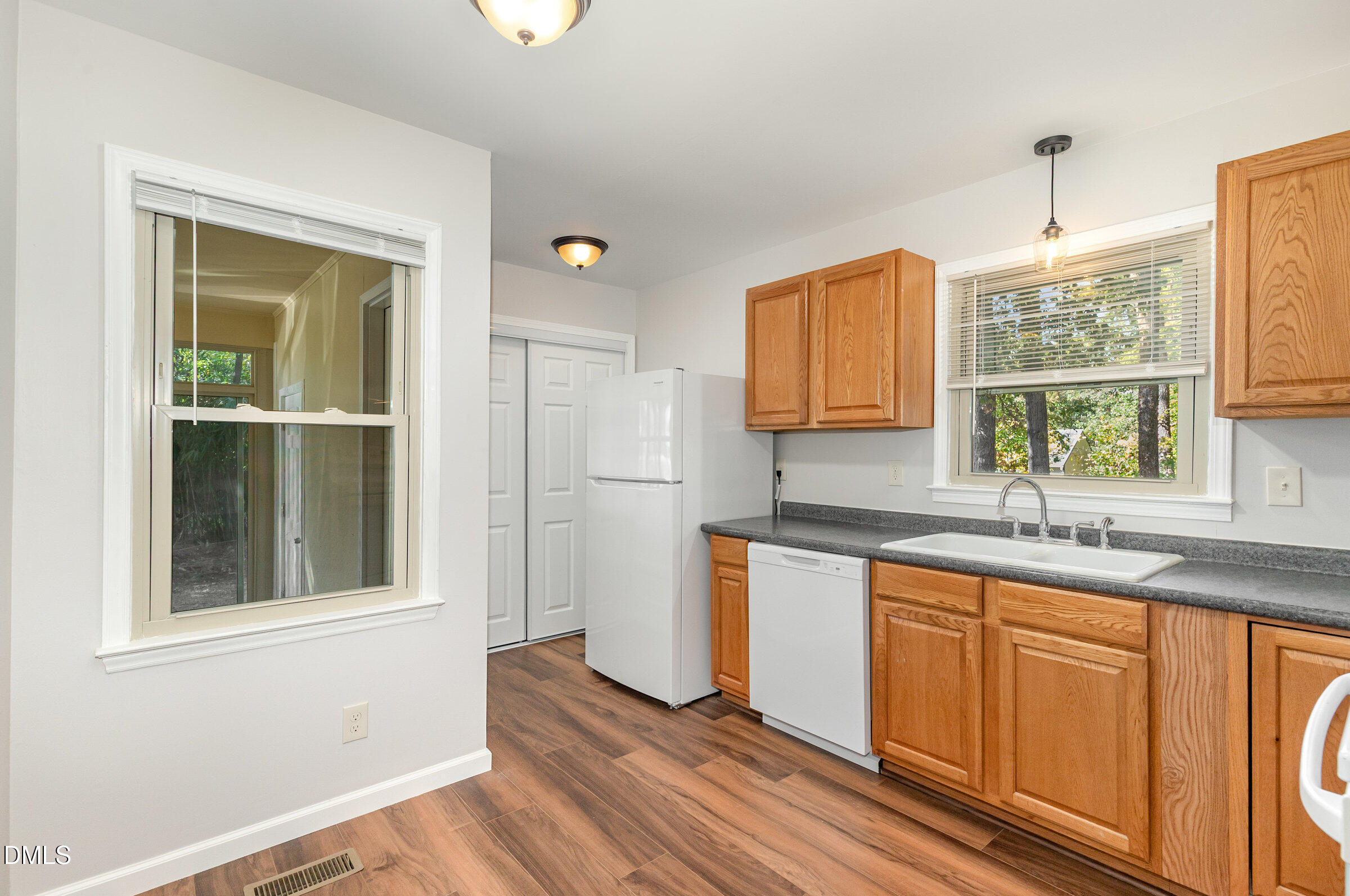 7020 Carpenter Fire Station Road Cary, NC 27519 - Photo 8 of 25 a kitchen with stainless steel appliances granite countertop a sink and dishwasher with wooden floor