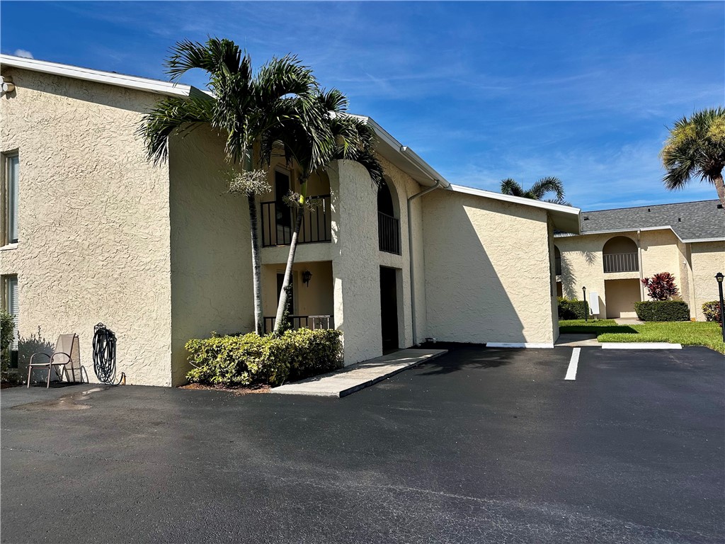 1815 Robalo Drive, Unit C201 Vero Beach, FL 32960 - Photo 22 of 31 a view of a house with backyard and a garage