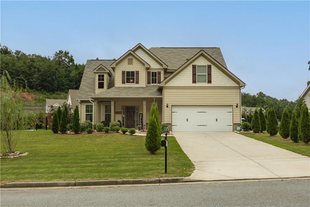 a view of a white house with a yard