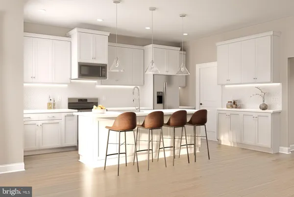 a kitchen with a dining table chairs and white cabinets
