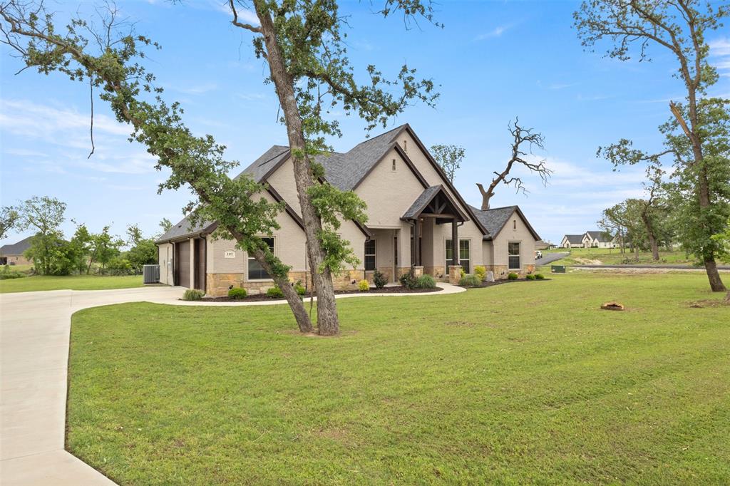 105 Clayton Crossing Springtown, TX 76082 - Photo 2 of 40 a front view of a house with a yard