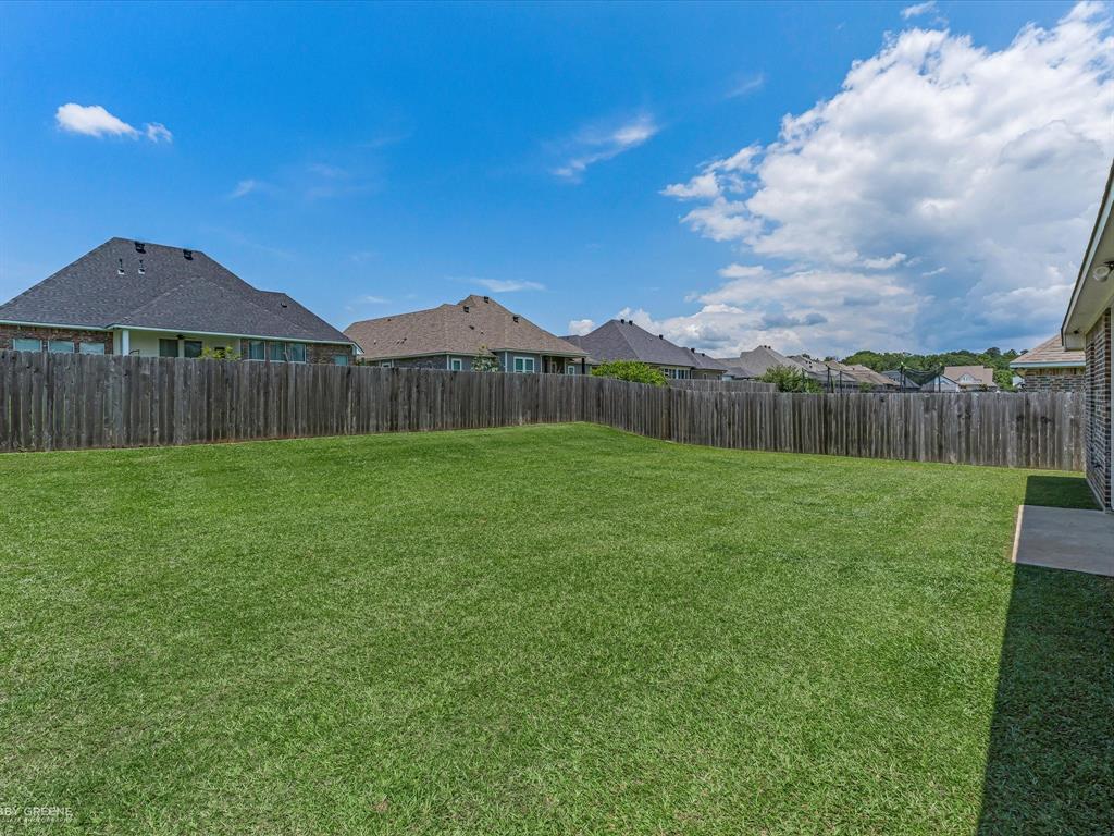 690 Lessie Drive Stonewall, LA 71078 - Photo 29 of 29 Expansive grass yard with a wood privacy fence