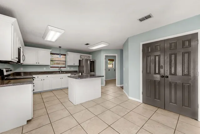 a kitchen with cabinets and white appliances