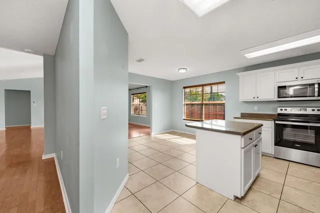 a kitchen with stainless steel appliances granite countertop a stove and a sink